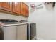 Modern laundry room with front-load washer and dryer, along with sleek cabinetry at 42350 Forest Oaks Dr, Elizabeth, CO 80107