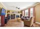 Comfortable living room with a fireplace, built-in shelves, and large windows at 42350 Forest Oaks Dr, Elizabeth, CO 80107