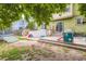 Fully fenced backyard with a patio, sandbox, and play equipment for outdoor activities and enjoyment at 676 Hedgerow Way, Brighton, CO 80601