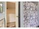 Full bathroom featuring a floral shower curtain and an open doorway to the basement at 676 Hedgerow Way, Brighton, CO 80601