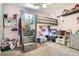Charming bedroom with a bunk bed, shelving for display, and a cozy atmosphere at 676 Hedgerow Way, Brighton, CO 80601