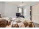 Comfortable bedroom featuring a cozy bed, TV, and closet with sliding doors at 676 Hedgerow Way, Brighton, CO 80601