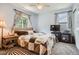 Cozy bedroom featuring a bed with a patterned quilt, curtains, and a TV at 676 Hedgerow Way, Brighton, CO 80601