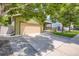 Home featuring a long driveway and charming exterior with front porch and attached garage at 676 Hedgerow Way, Brighton, CO 80601