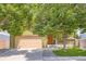 A charming home featuring a large driveway, front porch, and lush green lawn at 676 Hedgerow Way, Brighton, CO 80601