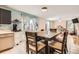 Bright kitchen with tile floors and a dining table at 676 Hedgerow Way, Brighton, CO 80601