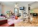 Inviting living room with a fireplace, television, fan, and a play area, perfect for Gathering gatherings at 676 Hedgerow Way, Brighton, CO 80601