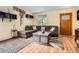 Cozy living room features a large sectional sofa and stylish decor at 676 Hedgerow Way, Brighton, CO 80601