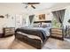 Comfortable main bedroom with a dark wood bed frame, side tables, and decor at 676 Hedgerow Way, Brighton, CO 80601