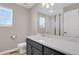 Bathroom featuring white countertops, modern vanity, and large mirror at 26167 E Byers Pl, Aurora, CO 80018