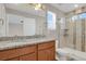 Bathroom with granite countertops, double sinks, and glass shower at 26167 E Byers Pl, Aurora, CO 80018