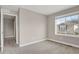 Bedroom with neutral colors and a window overlooking the neighborhood at 26167 E Byers Pl, Aurora, CO 80018