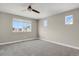 Large bedroom with neutral carpeting, three windows, and a ceiling fan, providing ample natural light at 26167 E Byers Pl, Aurora, CO 80018