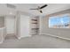 Spacious bedroom includes a ceiling fan, a window for natural light, built-in shelves, and a closet at 26167 E Byers Pl, Aurora, CO 80018