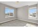 Bedroom featuring neutral carpet, paint, and large sunny windows at 26167 E Byers Pl, Aurora, CO 80018
