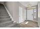 Inviting entryway with hardwood floors, a modern chandelier, and a staircase leading to the upper level at 26167 E Byers Pl, Aurora, CO 80018
