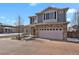 Beautiful two-story home showcasing stone accents, a spacious garage, and a well-manicured brick driveway at 26167 E Byers Pl, Aurora, CO 80018