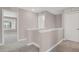 Second floor hallway with neutral carpeting and white railing, offering views into the bedrooms at 26167 E Byers Pl, Aurora, CO 80018