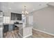 A modern kitchen featuring granite countertops, stainless appliances, and ample lighting at 26167 E Byers Pl, Aurora, CO 80018
