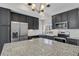 A modern kitchen featuring sleek appliances, granite countertops, and ample storage space at 26167 E Byers Pl, Aurora, CO 80018