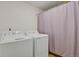 Laundry room with washer, dryer, and privacy curtain at 26167 E Byers Pl, Aurora, CO 80018