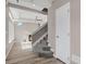 Open-concept living area with a fireplace, carpeted stairs, wood floors, and abundant natural light at 26167 E Byers Pl, Aurora, CO 80018