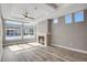 A sun-drenched living room with a traditional fireplace and wood-look tile at 26167 E Byers Pl, Aurora, CO 80018