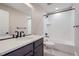 Clean bathroom with a single vanity, modern fixtures, and a shower-tub combination at 2443 W 69Th Pl, Denver, CO 80221