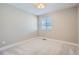 Bright bedroom with carpet, neutral walls, and a window with blinds at 2443 W 69Th Pl, Denver, CO 80221