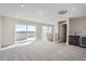 Bright bonus room featuring a bar area and access to an outdoor deck at 2443 W 69Th Pl, Denver, CO 80221