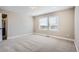 A spacious, carpeted main bedroom with large windows offering natural light at 2443 W 69Th Pl, Denver, CO 80221