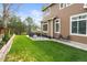 Well-manicured backyard with lush lawn, stone patio, and outdoor seating, perfect for relaxing and entertaining at 17297 Opal Hill Dr, Parker, CO 80134
