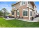 Spacious backyard featuring a stone patio, lush lawn, and beautiful two-story home at 17297 Opal Hill Dr, Parker, CO 80134
