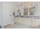 Bright bathroom with double vanity, granite countertop, and large mirror at 17297 Opal Hill Dr, Parker, CO 80134
