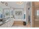 Bright bathroom with double vanity, granite countertop, large mirror, soaking tub, and shower at 17297 Opal Hill Dr, Parker, CO 80134