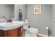 Well-appointed half bath with a stylish vanity, contemporary fixtures and gray paint at 17297 Opal Hill Dr, Parker, CO 80134