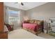 Comfortable bedroom with a daybed, a ceiling fan, and a view to the outside at 17297 Opal Hill Dr, Parker, CO 80134