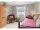 Comfortable bedroom area features a daybed, ceiling fan, and natural light at 17297 Opal Hill Dr, Parker, CO 80134