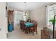 Bright dining room with large windows, elegant chandelier, and spacious seating area at 17297 Opal Hill Dr, Parker, CO 80134