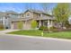 Beautiful two-story home with manicured lawn, decorative fence, and inviting curb appeal at 17297 Opal Hill Dr, Parker, CO 80134