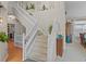 Bright foyer with elegant staircase, neutral tones, and seamless transition to the living area at 17297 Opal Hill Dr, Parker, CO 80134