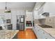 Well-designed kitchen with stainless steel appliances, granite countertops, and a view into the adjacent dining room at 17297 Opal Hill Dr, Parker, CO 80134