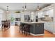 Open-concept kitchen with granite countertops, island seating, and stainless steel appliances offers a welcoming space at 17297 Opal Hill Dr, Parker, CO 80134