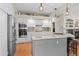 Modern kitchen with stainless steel appliances, an island with seating, and sleek cabinetry offers a functional layout at 17297 Opal Hill Dr, Parker, CO 80134