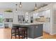 Spacious kitchen featuring granite countertops, an island with seating, and modern stainless steel appliances at 17297 Opal Hill Dr, Parker, CO 80134