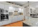 Modern kitchen featuring stainless steel appliances, granite countertops, and white cabinetry for a clean aesthetic at 17297 Opal Hill Dr, Parker, CO 80134