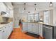 Bright kitchen with stainless steel appliances and granite countertops seamlessly connects to the cozy living space at 17297 Opal Hill Dr, Parker, CO 80134