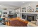 Inviting living room with hardwood floors, fireplace, and seamlessly connecting to the kitchen for easy living at 17297 Opal Hill Dr, Parker, CO 80134