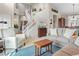 Spacious living room featuring a high ceiling, staircase, and abundant natural light at 17297 Opal Hill Dr, Parker, CO 80134