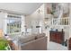 Bright living room with soaring ceilings, elegant staircase, and large picture window at 17297 Opal Hill Dr, Parker, CO 80134